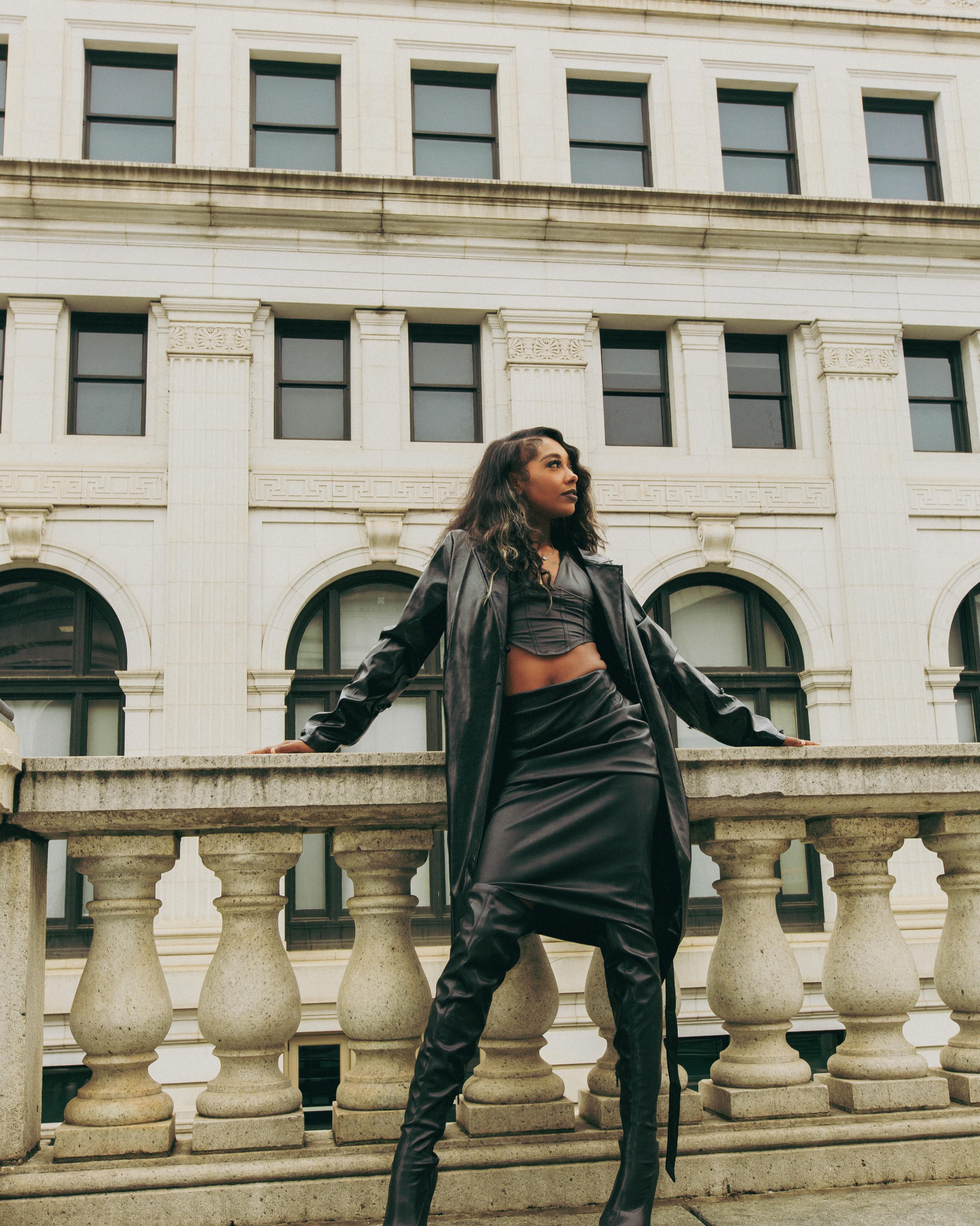 Slycee in a black leather look with long dimensional waves