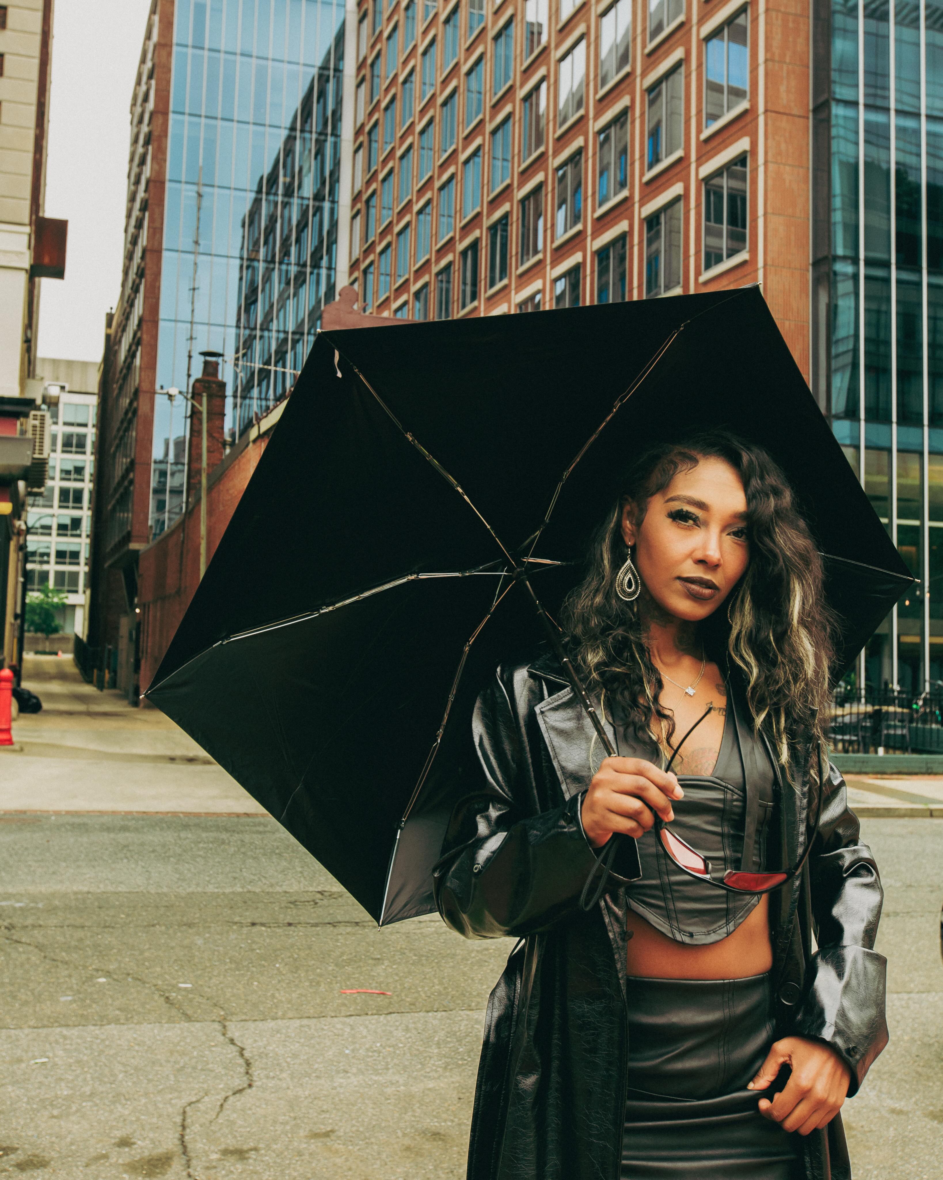 Slycee holding an umbrella with long dimensional waves
